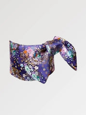 Violet-navy brocade obi belt with pink and white cherry blossoms and chrysanthemums and gold detail, flat product view showing the full sash and knot