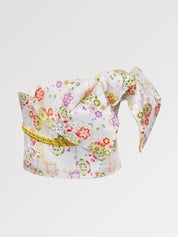 White and silver brocade obi belt with tiny red, green and violet flowers and a gold cord, flat product view showing the full sash and knot